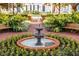 Charming tiered water fountain surrounded by flowerbeds in a brick-lined community green space at 1106 Celebration Ave, Celebration, FL 34747