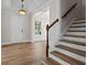 Bright foyer with hardwood floors, staircase, chandelier, and a view into another room at 1106 Celebration Ave, Celebration, FL 34747