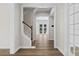 Hallway featuring hardwood floors, stairs with wood handrail, and glass doors at 1106 Celebration Ave, Celebration, FL 34747