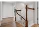 Hallway features hardwood floors and a wood staircase with white wood trim. It is brightly lit with natural light at 1106 Celebration Ave, Celebration, FL 34747