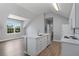 Open-concept kitchen with island, stainless steel appliances, and wood floors at 1106 Celebration Ave, Celebration, FL 34747