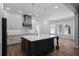 Bright kitchen with a large island, stainless steel appliances, custom cabinetry, and modern pendant lighting at 1106 Celebration Ave, Celebration, FL 34747