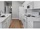 Well-lit kitchen with white cabinets, countertops, and wood-look flooring at 1106 Celebration Ave, Celebration, FL 34747