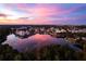 A stunning lake view reflecting a vibrant sunset over a picturesque community at 1106 Celebration Ave, Celebration, FL 34747