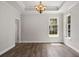 Living room featuring hardwood floors, tray ceiling, large windows, and white trim at 1106 Celebration Ave, Celebration, FL 34747