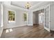 Bright, open living room with hardwood floors, tray ceiling, and double doors at 1106 Celebration Ave, Celebration, FL 34747