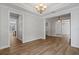 Open-concept living room featuring hardwood floors, a chandelier, and ample natural light, seamlessly connecting to other spaces at 1106 Celebration Ave, Celebration, FL 34747