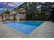 This enclosed in-ground pool area features tile flooring, barbecue, and lounge seating at 1106 Celebration Ave, Celebration, FL 34747