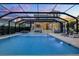 Beautiful pool with a screened enclosure, patio with furniture, and a lovely home at 1106 Celebration Ave, Celebration, FL 34747