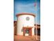 Front view of the community post office featuring a US flag, red brick, and a cylindrical design at 1106 Celebration Ave, Celebration, FL 34747