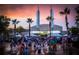 A vibrant town center with people enjoying fountains under a colorful sunset sky in Celebration, Florida at 1106 Celebration Ave, Celebration, FL 34747