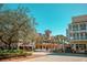 Charming town center with colorful buildings, palm trees, and street parking under a clear blue sky at 1106 Celebration Ave, Celebration, FL 34747