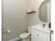 Powder room featuring a vanity with a white cabinet, an oval mirror, and modern fixtures at 12272 Bracco St, Winter Garden, FL 34787
