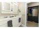 Bathroom with double sinks, white cabinets, and walk-in closet for comfort and convenience at 12272 Bracco St, Winter Garden, FL 34787