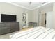 Well-lit bedroom boasts a large TV, neutral walls, and access to a bathroom and closet for convenience at 12272 Bracco St, Winter Garden, FL 34787