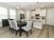 Bright dining area seamlessly connects to the kitchen, complete with sleek appliances and stylish finishes at 12272 Bracco St, Winter Garden, FL 34787