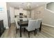 Chic dining area flows into the kitchen, featuring modern lighting and ample seating for entertaining at 12272 Bracco St, Winter Garden, FL 34787
