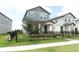 Charming two-story home with a fenced yard, green grass, and a welcoming front porch at 12272 Bracco St, Winter Garden, FL 34787
