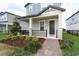 Charming front porch with brick walkway, complemented by lush landscaping and a cozy, inviting ambiance at 12272 Bracco St, Winter Garden, FL 34787