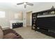 Carpeted loft space with a seating area, entertainment center, and natural light at 12272 Bracco St, Winter Garden, FL 34787