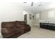 Comfortable loft featuring a plush couch, carpet flooring, and an entertainment area with a storage cabinet at 12272 Bracco St, Winter Garden, FL 34787
