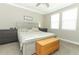 Bedroom featuring a bed with a neutral color scheme, side tables, and a wood storage chest at 12272 Bracco St, Winter Garden, FL 34787