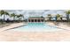 A luxurious community pool with ample lounge seating and clear blue water at 12272 Bracco St, Winter Garden, FL 34787
