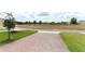 An empty lot sits across the street from the home with a sidewalk and green grass at 12272 Bracco St, Winter Garden, FL 34787