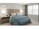 Serene bedroom with a wooden headboard, cozy linens, and bedside tables with lamps for a relaxing retreat at 12954 Promise Pl, Orlando, FL 32832
