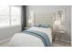 Relaxing bedroom with an upholstered headboard, neutral colors, bedside tables, and soft, inviting bedding at 12954 Promise Pl, Orlando, FL 32832