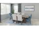Dining area featuring a classic dining table with seating for six, and a large window allowing natural light at 12954 Promise Pl, Orlando, FL 32832