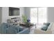Cozy living room with neutral tones, comfortable seating, a large window, and access to outdoor space at 12954 Promise Pl, Orlando, FL 32832