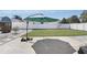 Spacious backyard featuring a well-maintained lawn, a charming patio umbrella, and secure fencing at 1325 Mcneil Rd, Altamonte Springs, FL 32714