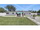 Well-maintained backyard with green lawn, privacy fence, patio area with umbrella and grill, solar panels, and water feature at 1325 Mcneil Rd, Altamonte Springs, FL 32714