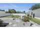 Beautiful backyard showcasing a green lawn, rock landscaping, and a multi-tiered fountain at 1325 Mcneil Rd, Altamonte Springs, FL 32714