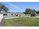 Expansive backyard featuring a lush lawn, privacy fencing, charming shed, outdoor grill, patio umbrella and solar panels at 1325 Mcneil Rd, Altamonte Springs, FL 32714