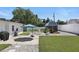 Landscaped backyard with a shed, privacy fence, manicured lawn, concrete patio, and a charming water fountain at 1325 Mcneil Rd, Altamonte Springs, FL 32714