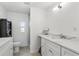 Bright bathroom with double vanity, quartz counters, and a shower with glass door at 1325 Mcneil Rd, Altamonte Springs, FL 32714