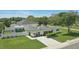 Bright home featuring a manicured lawn, privacy fence, and an extra outdoor building on a spacious lot at 1325 Mcneil Rd, Altamonte Springs, FL 32714