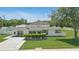 Charming single story home with a manicured lawn and updated landscaping, complete with a clean, freshly painted driveway at 1325 Mcneil Rd, Altamonte Springs, FL 32714