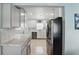 Bright, modern kitchen features stainless steel appliances, white cabinetry and tile backsplash at 1325 Mcneil Rd, Altamonte Springs, FL 32714