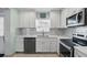 Well-lit kitchen featuring stainless steel appliances, white cabinetry, and tile backsplash at 1325 Mcneil Rd, Altamonte Springs, FL 32714