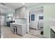 Open concept kitchen with gray cabinets, tile backsplash, and access to the living area and bathroom at 1325 Mcneil Rd, Altamonte Springs, FL 32714