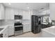 Modern kitchen with white cabinets, stainless steel appliances, and a view of the dining area at 1325 Mcneil Rd, Altamonte Springs, FL 32714