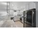 Modern kitchen features stainless steel appliances, white cabinetry, and tile backsplash at 1325 Mcneil Rd, Altamonte Springs, FL 32714