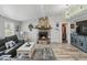 Cozy living room features a stone fireplace, wood-look floors, and modern decor, blending comfort with style at 1325 Mcneil Rd, Altamonte Springs, FL 32714