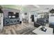 Spacious living room with wood-look tile floors, modern fixtures, and neutral color palette at 1325 Mcneil Rd, Altamonte Springs, FL 32714
