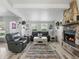 Inviting living room boasts stone fireplace, neutral tones, and wood-look tile flooring at 1325 Mcneil Rd, Altamonte Springs, FL 32714