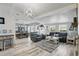 Bright living room features an open layout, wood-look tile floors, and modern light fixture at 1325 Mcneil Rd, Altamonte Springs, FL 32714
