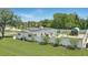 Property boasts solar panels, manicured lawn, a small outdoor structure, and a well-maintained white fence for privacy at 1325 Mcneil Rd, Altamonte Springs, FL 32714